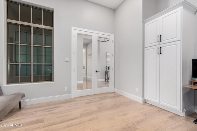 interior space with french doors and light hardwood / wood-style floors