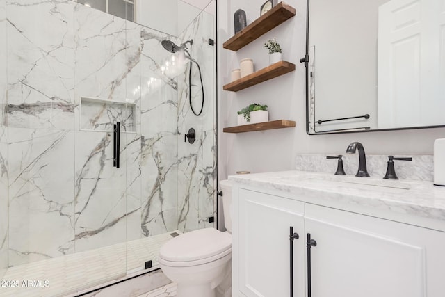 bathroom with an enclosed shower, vanity, and toilet