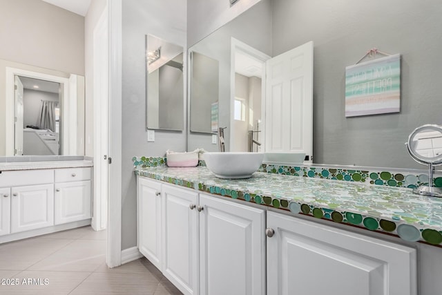 bathroom with tile patterned floors and vanity