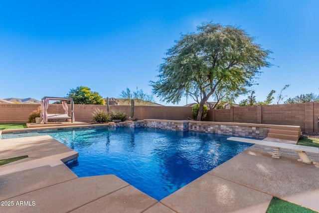 view of pool with a patio and pool water feature