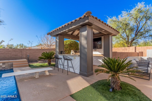 view of patio / terrace with a gazebo, exterior bar, and area for grilling