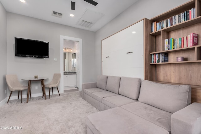 carpeted living room featuring ceiling fan