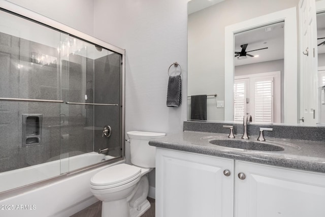 full bathroom with shower / bath combination with glass door, toilet, ceiling fan, and vanity