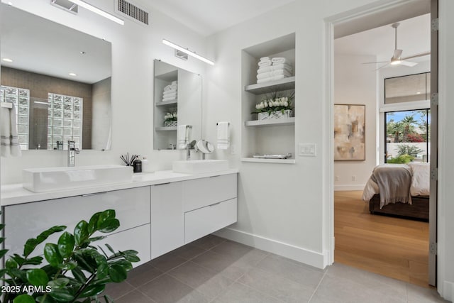 bathroom featuring built in shelves, ceiling fan, vanity, and tile patterned flooring