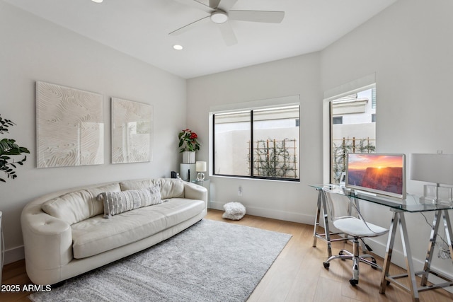 living room featuring ceiling fan and light hardwood / wood-style floors