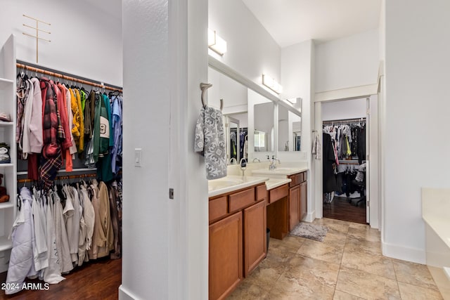 bathroom featuring a tub, vanity, and wood-type flooring