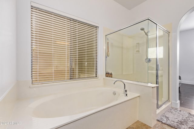 bathroom with shower with separate bathtub