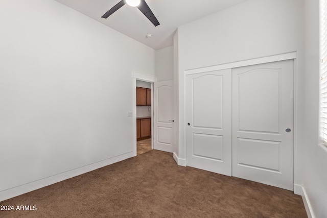 unfurnished bedroom with ceiling fan, a closet, and carpet floors