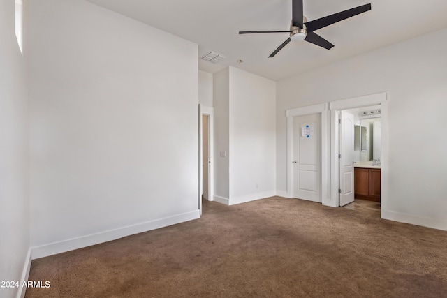 unfurnished bedroom featuring carpet floors, ceiling fan, and ensuite bathroom