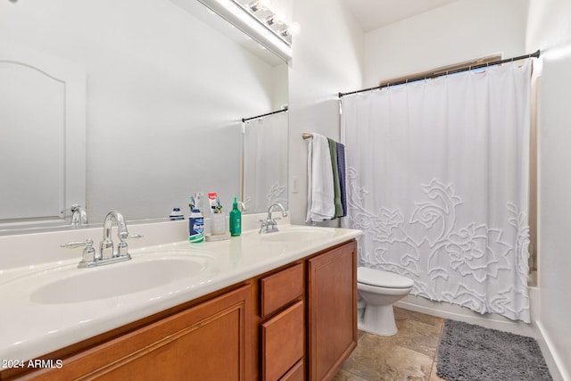 full bathroom featuring tile patterned flooring, shower / bath combo with shower curtain, vanity, and toilet