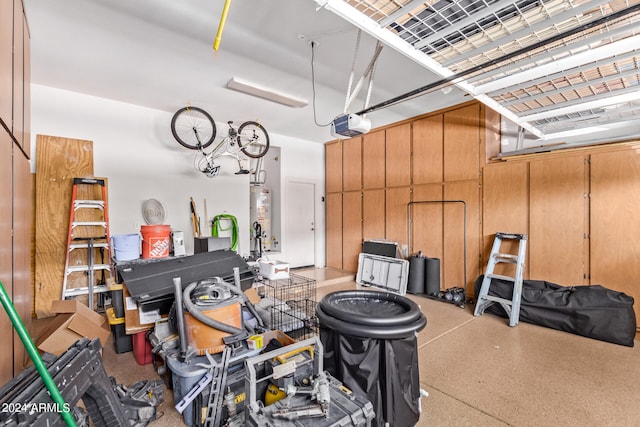 garage with water heater, a garage door opener, and wooden walls