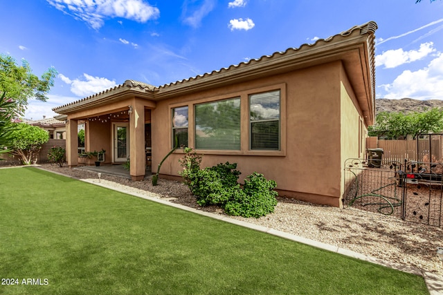 rear view of property with a lawn