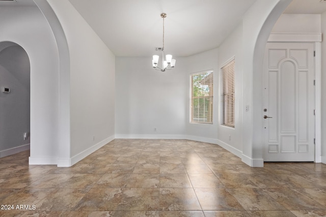 interior space featuring tile patterned floors and an inviting chandelier