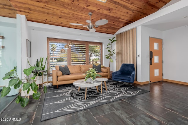 living area with lofted ceiling, wood ceiling, ceiling fan, and baseboards