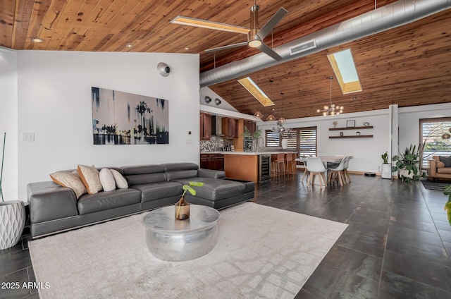 living room with visible vents, high vaulted ceiling, a skylight, and wooden ceiling