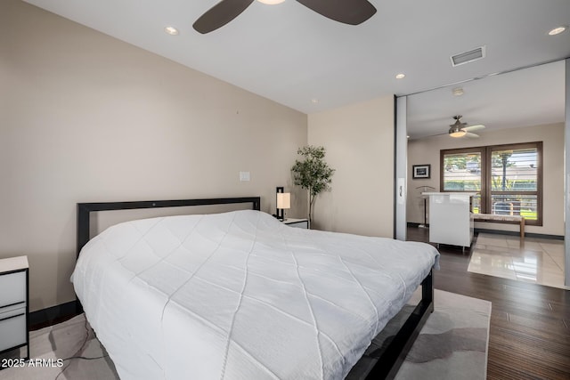 bedroom featuring baseboards, wood finished floors, visible vents, and recessed lighting