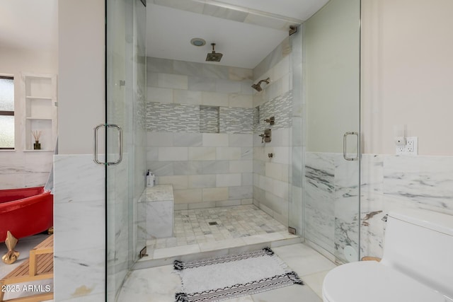 bathroom featuring toilet, a shower stall, tile walls, and wainscoting