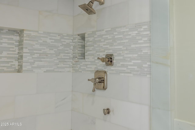 interior details with a tile shower