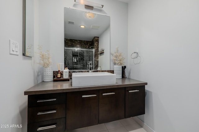 bathroom with visible vents, vanity, and a shower stall