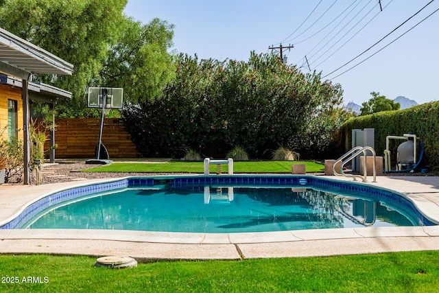 view of pool with a fenced in pool, a fenced backyard, and a lawn