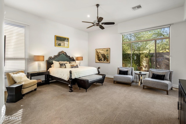 bedroom with visible vents, carpet floors, baseboards, and ceiling fan