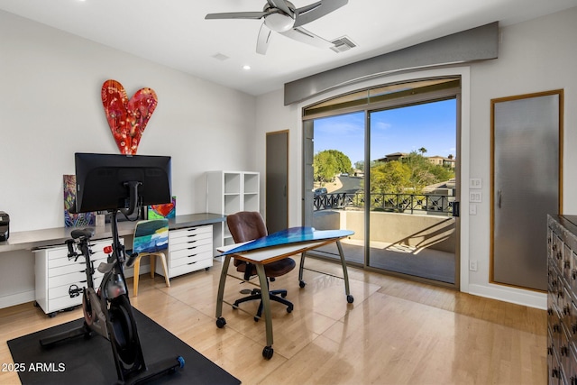 office space featuring visible vents, baseboards, a ceiling fan, and wood finished floors