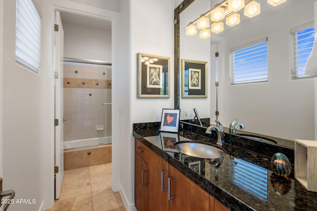 full bathroom with tile patterned flooring, vanity, and tiled shower / bath combo