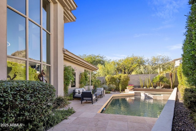 view of pool with a fenced backyard, an outdoor living space, an in ground hot tub, and a patio