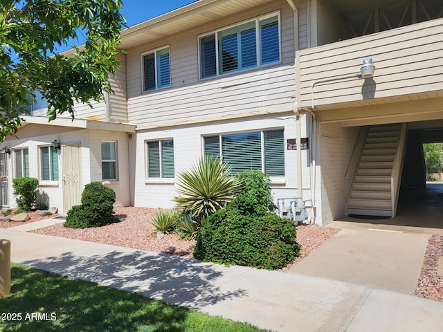 8221 E Garfield St Unit L109, Scottsdale, AZ 85257 - view of front of house with a balcony and brick siding