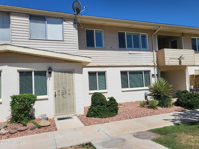8221 E Garfield St Unit L109, Scottsdale, AZ 85257 - view of front of property with brick siding and a balcony