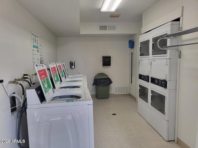 8221 E Garfield St Unit L109, Scottsdale, AZ 85257 - community laundry room featuring stacked washing machine and dryer, washing machine and dryer, and light flooring