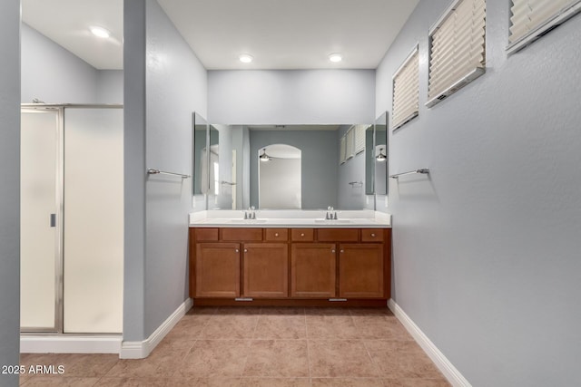 bathroom featuring tile patterned flooring, walk in shower, and vanity