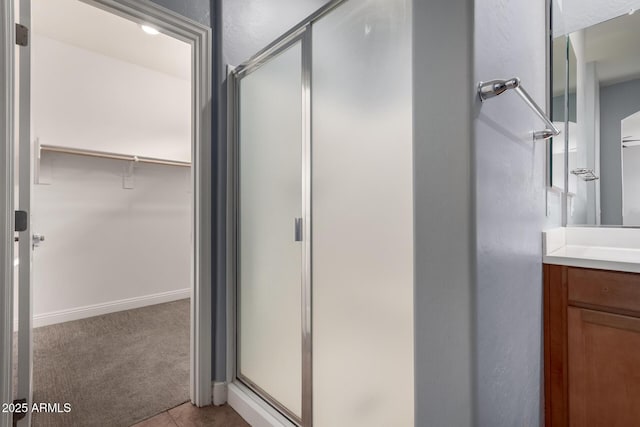 bathroom with walk in shower and vanity