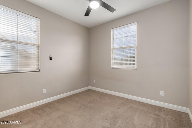 spare room featuring ceiling fan and light colored carpet