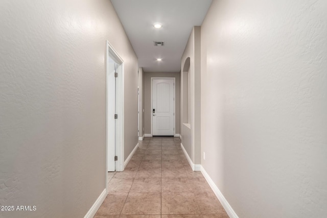 hall with light tile patterned floors