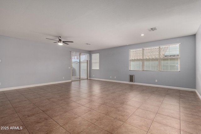 tiled spare room with ceiling fan