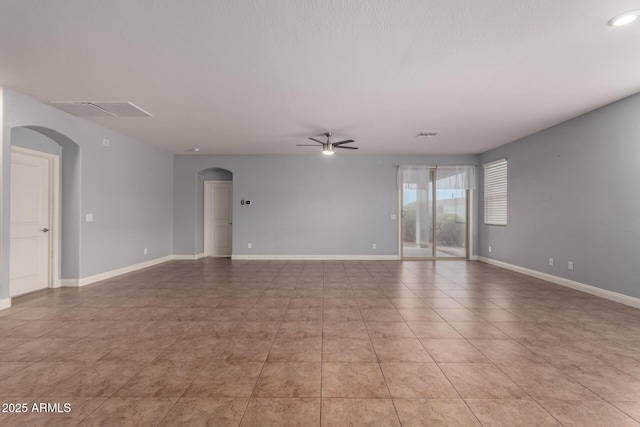 tiled spare room with ceiling fan and a textured ceiling