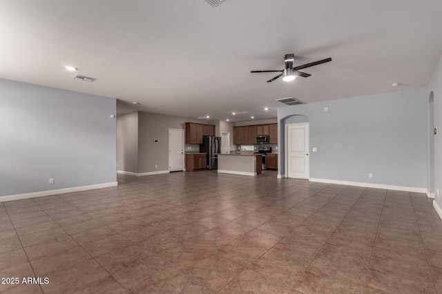 unfurnished living room featuring ceiling fan