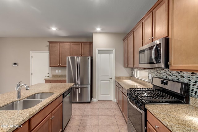 kitchen featuring backsplash, sink, appliances with stainless steel finishes, light tile patterned floors, and light stone counters