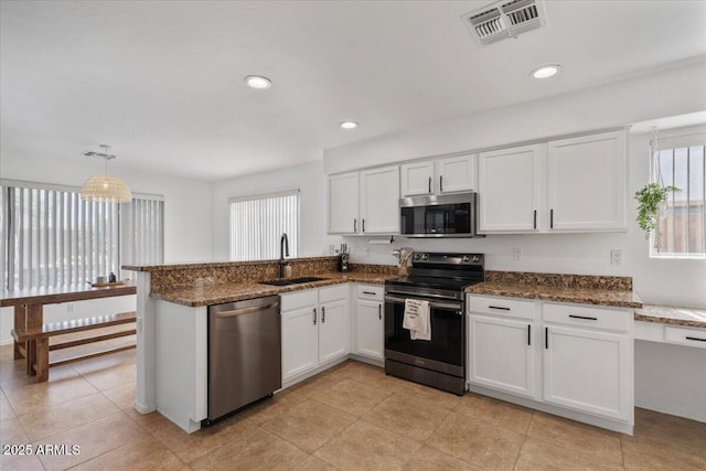 4323 E Dublin St, Gilbert, AZ 85295 - kitchen with appliances with stainless steel finishes, a sink, plenty of natural light, white cabinetry, and recessed lighting