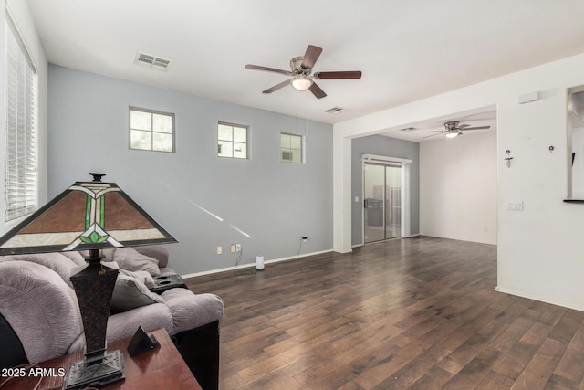 living room with ceiling fan and dark hardwood / wood-style flooring