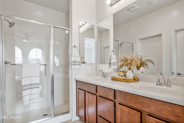 bathroom featuring vanity and a shower with shower door