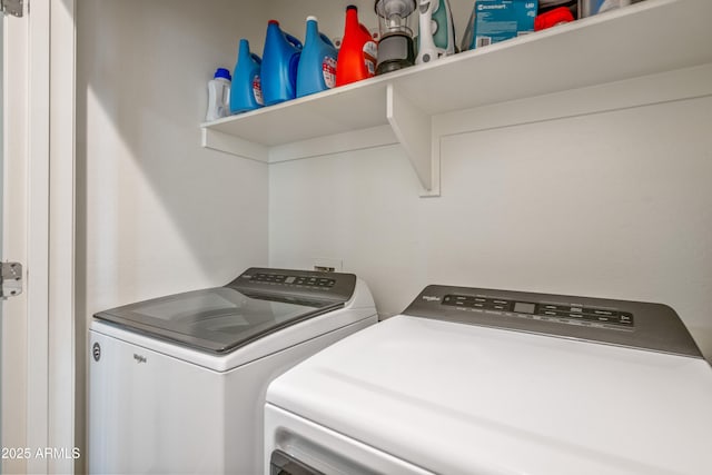 clothes washing area with washing machine and dryer