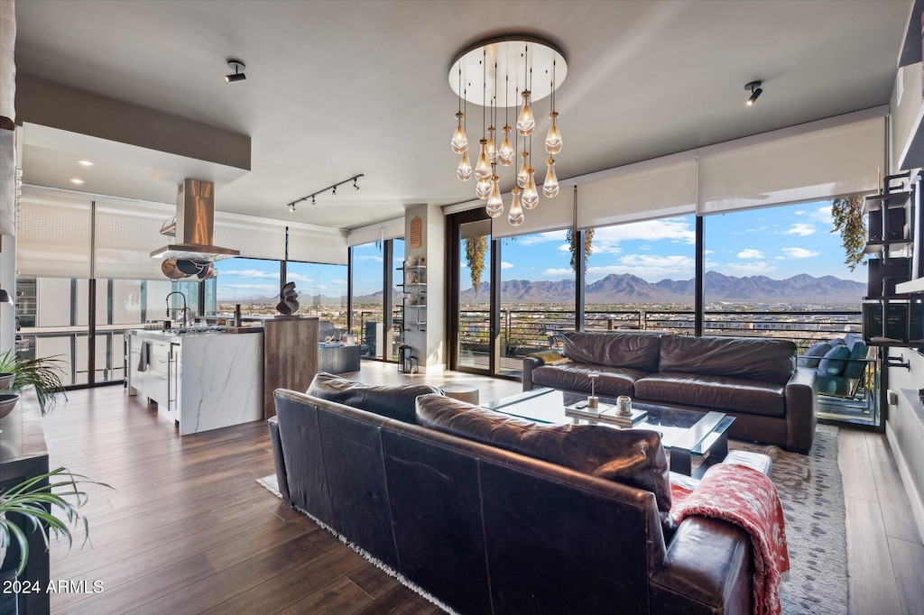 living room featuring a notable chandelier, a mountain view, dark hardwood / wood-style floors, and expansive windows