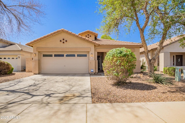 12355 W Hadley St, Avondale, AZ 85323 - mediterranean / spanish-style house featuring stucco siding, driveway, an attached garage, and a tile roof