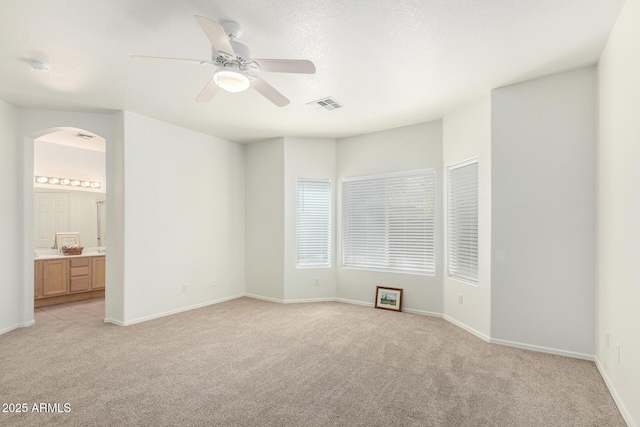12355 W Hadley St, Avondale, AZ 85323 - unfurnished bedroom featuring light colored carpet, arched walkways, and baseboards