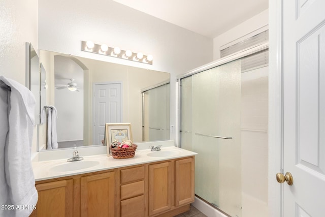 12355 W Hadley St, Avondale, AZ 85323 - bathroom featuring a stall shower, double vanity, and a ceiling fan
