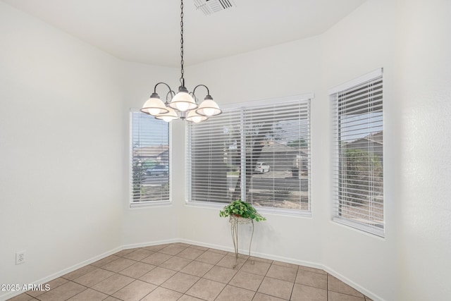12355 W Hadley St, Avondale, AZ 85323 - unfurnished dining area with a chandelier, light tile patterned flooring, and baseboards
