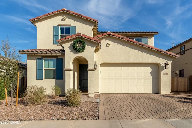 mediterranean / spanish-style home with a garage