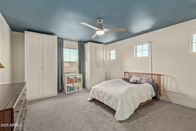 carpeted bedroom featuring ceiling fan